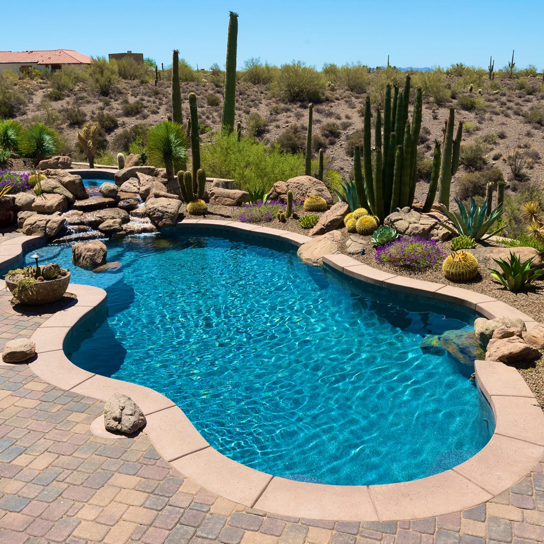 a pool in arizona with the desert in the background